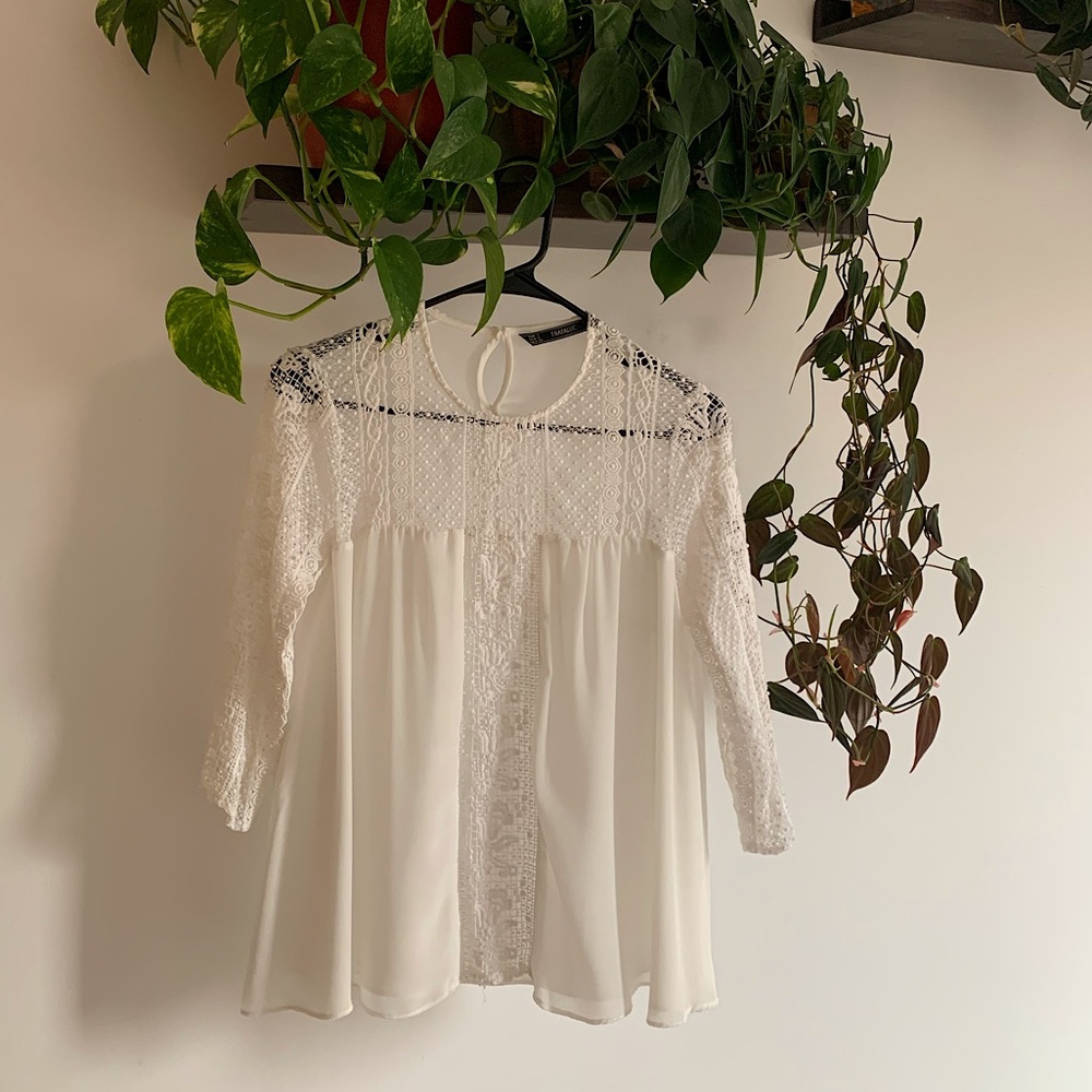 Delicate Zara white blouse. Flowy at the bottom and Lacey on the top.